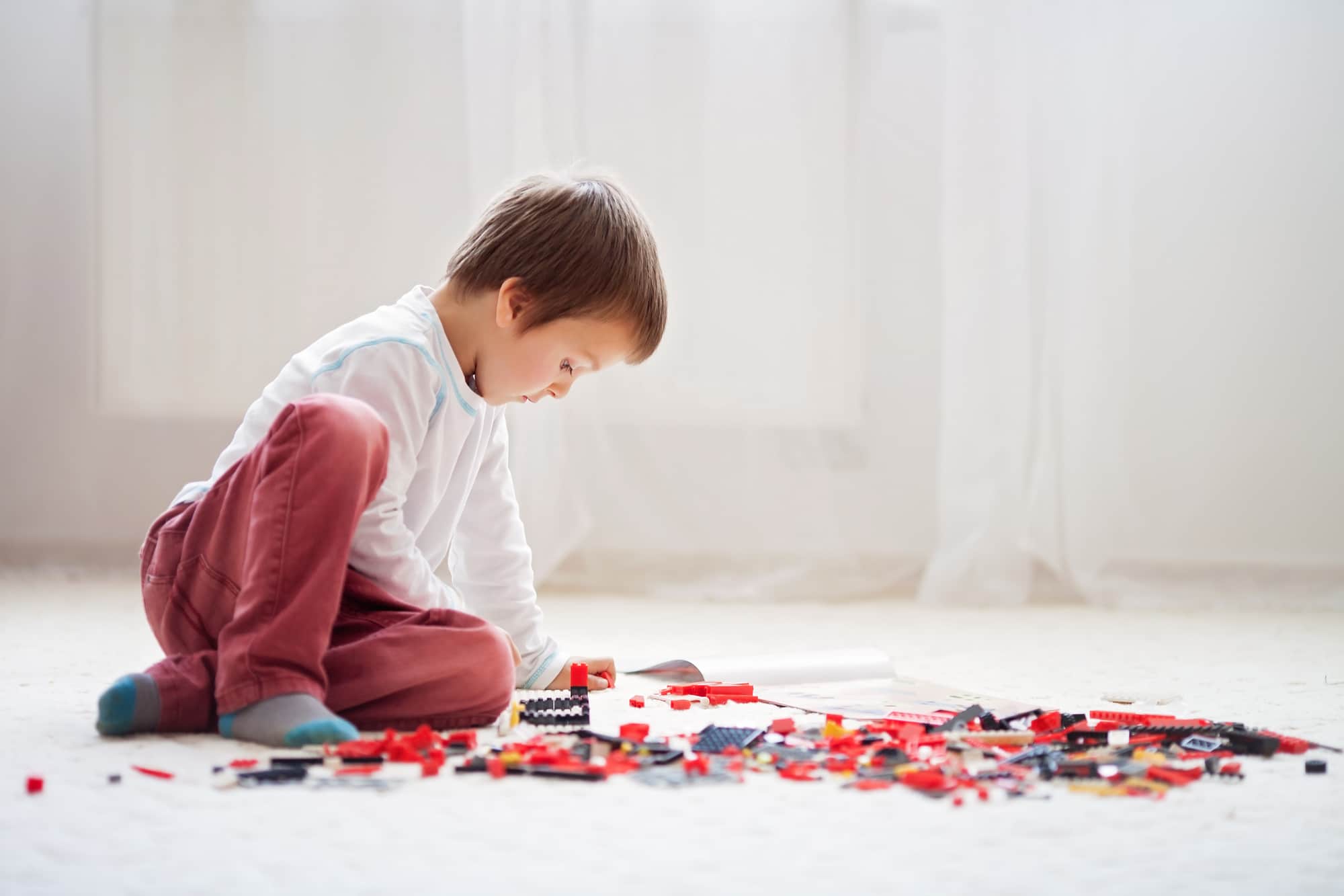 Little child playing with lots of colorful plastic blocks indoor lego-swot-analysis-opportunities